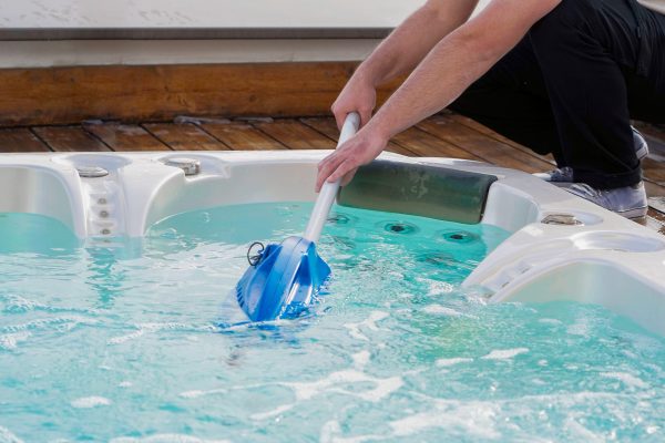 Hotel staff worker cleaning the hot tub